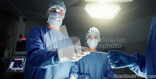 Image of Doctors, team and equipment in surgery, healthcare and treatment for injury, support and trust. Surgeons, collaboration and hands over tool, teamwork and operation in theatre, medicare and hospital