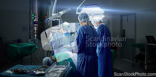 Image of Healthcare, teamwork and doctors in a hospital for an operation together, working in theater to save a life. Medical, emergency and a surgeon team in the operating room of a clinic for surgery