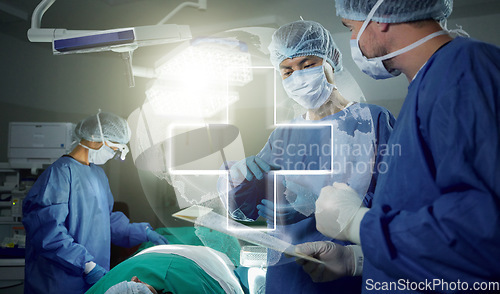 Image of Hologram, teamwork and doctors in a hospital for surgery together, working in theater to save a life. World healthcare, medical and a surgeon team in the operating room of a clinic for an operation