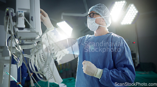 Image of Healthcare, monitor and vital with a doctor in theater getting ready for surgery in a hospital operating room. Medical, technology and equipment with a surgeon in a clinic as a medicine professional