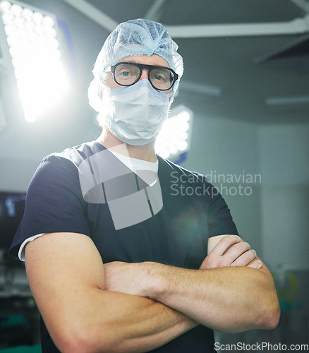 Image of Surgeon, man or portrait in theater or confident healthcare, professional or expert help. Male person, face mask or hospital operating room or medicine support, doctor or emergency care service trust