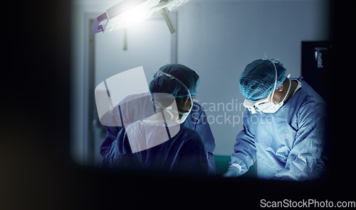 Image of Teamwork, emergency and doctors in a hospital for surgery together, working in theater to save a life. Medical, healthcare and a surgeon team in the operating room of a clinic for an operation