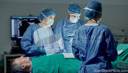 Image of Teamwork, hospital and doctors working on a surgery for medical treatment in a theatre room. Collaboration, career and professional surgeons doing a healthcare operation on a patient in a clinic.