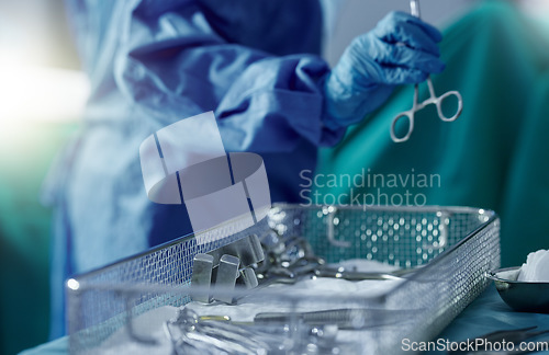 Image of Doctor, scissor and medical equipment in surgery, healthcare and treatment for injury, support and trust. Hand close up, tool and medicine in hospital, instrument and operation in theatre by medicare