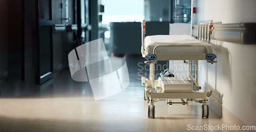 Image of Healthcare, medicine and a bed in the corridor of a hospital after work, ready for an emergency or accident. Medical, wellness and service with a gurney in the empty hallway of a health clinic