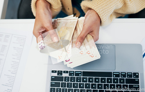 Image of Money, hand and business woman with laptop in office for budget, savings and investment from above. Cash, counting and lady investor with payment, loan or sale, deal and profit, growth or management