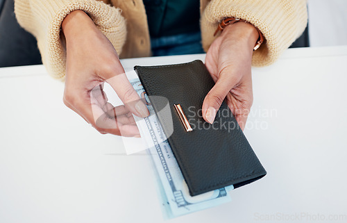 Image of Person, hands and wallet with money for savings, investment or payment on counter at checkout. Top view or closeup of employee with cash, bills or paper notes for finance, purchase or shopping
