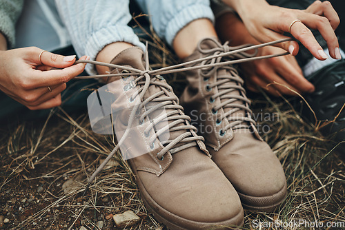 Image of Shoes, hands tie shoelace and hiking, person outdoor in nature for travel and adventure, explore and zoom. Boots, camping with start or prepare for walk, trekking and journey with health and fitness