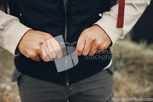 Image of Hands, backpack strap and person hiking in nature on holiday, vacation and travel. Closeup, trekking and fasten clasp or adjust outdoor in forest, woods and countryside in preparation for adventure