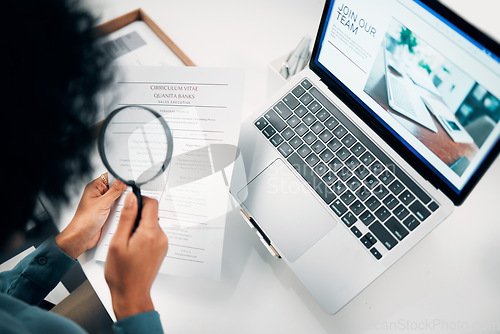 Image of Magnifying glass, computer and woman reading cv in office for company recruitment website. Research, technology and closeup of female designer with hiring paperwork and laptop in workplace.