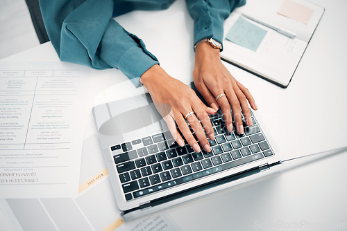 Image of Above, business and hands with typing on laptop, desk and office for career in human resources. Woman, corporate worker and writing on keyboard with pc, technology and internet on cv for job search