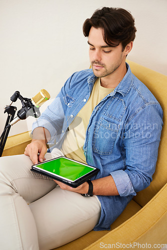Image of Man, tablet and green screen with mic for podcast, recording or music with mockup space on website. Talk show, online radio and chromakey touchscreen with microphone for chat, broadcast or thinking
