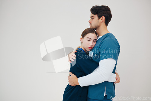 Image of Doctor, colleagues and tired stress for support, healthcare clinic or hug. Medical professionals, friends and helping comfort in scrubs on wall background, mockup space or fatigue trust at hospital