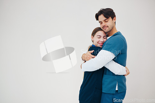 Image of Doctor, colleagues and hug smile at healthcare clinic, support or work stress. Medical professionals, friends or helping comfort in scrubs or wall background, mockup space or happy trust at hospital