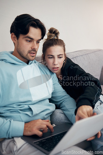Image of Laptop, stress and couple pointing in home living room for budget planning, taxes or debt. Computer, man and frustrated woman on sofa for finance, asset management and mortgage, loan and rent bills