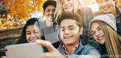 Image of Smile, friends and a selfie in nature for bonding, fun and video call in autumn. Happy, together and diversity of kids taking a photo on technology in a park for social media or live streaming