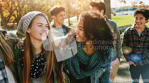 Image of Teenager, walking and talking with friends in park, nature or social group outdoor together with funny conversation. Happy, teen and kids laugh at joke with best friend in community or relax in fall