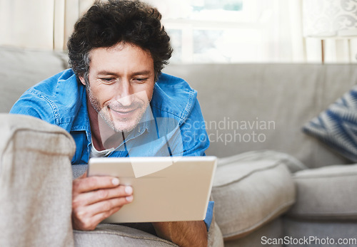 Image of Man, relax and tablet internet on sofa for digital contact, social media or movie app. Male person, streaming film and online shop connection or connectivity fun for comfort, weekend joy in house