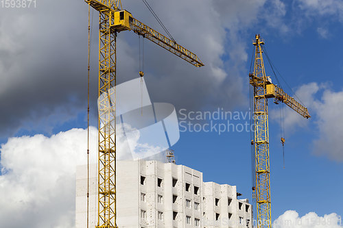 Image of construction cranes with construction equipment