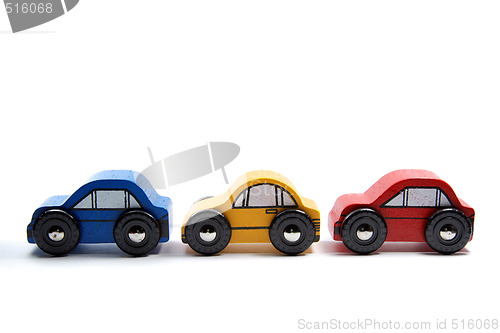 Image of Three wooden toy cars in a row