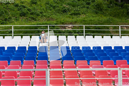 Image of Lonely woman on the empty stadium outdoor