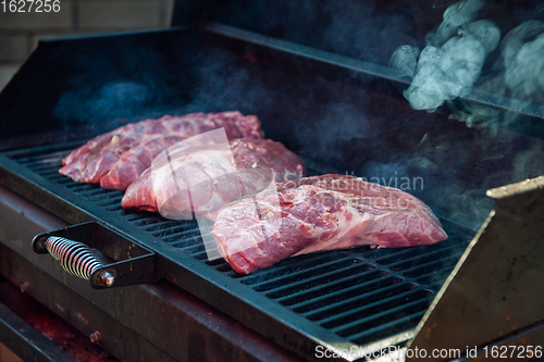 Image of Pork meat steaks on the grill