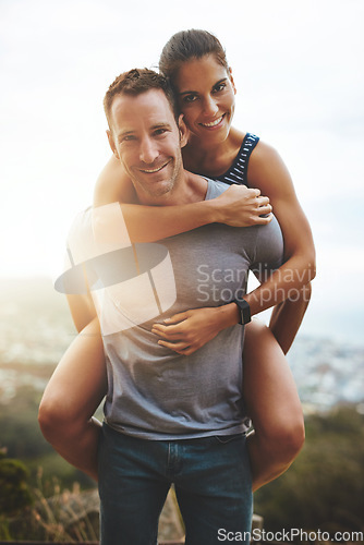 Image of Portrait, piggy back and couple with hug, outdoor or lens flare with happiness, love or freedom. Face, man carrying woman or journey with embrace, smile or outside with wellness, adventure or holiday