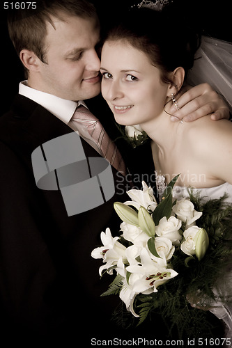 Image of Bride and groom kissing