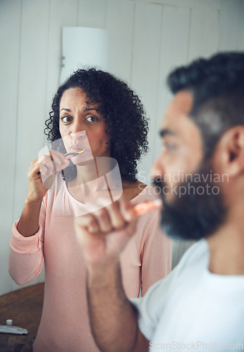 Image of Couple, brushing teeth and bathroom in morning, dental wellness and worry with thinking in home. Mature man, woman and toothbrush for cleaning mouth together with concern, stress or hygiene in house