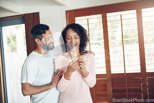 Image of Couple, excited and positive pregnancy test at home, hug and happy for future, support and love. Smiling people, success and pregnant by ivf, fertility and good news, results and celebration for baby