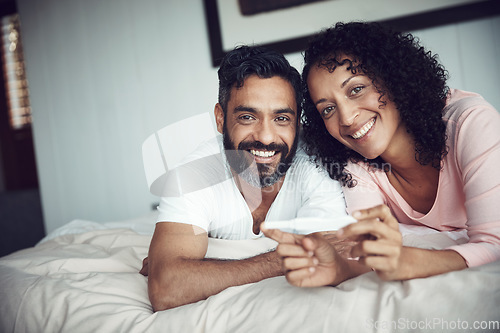 Image of Couple, happy and portrait with pregnancy test, bedroom and positive with smiling, results and excited. Man, woman and baby with stick, love and maternity for future family, surprise and pregnant