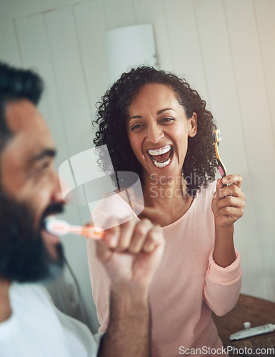 Image of Cleaning, teeth and couple in bathroom with dental, healthcare and wellness in home. Happy, smile and people washing mouth with toothbrush, toothpaste and healthy brushing together in morning routine