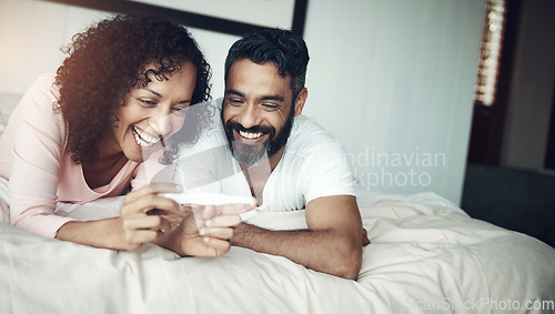 Image of Couple, happy and bedroom with pregnancy test, positive and bed with smile, results and excited. Man, woman and baby with stick, love and maternity for future family, surprise and pregnant together