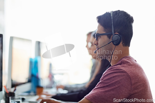 Image of Business man, call center and computer for customer service, sales agency and telemarketing in workspace. Professional consultant, agent or employees in telecom office for contact us and virtual chat