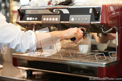 Image of Coffee machine, closeup and man barista in a cafe making latte, cappuccino or espresso in a cup. Equipment, mug and zoom of male waiter or small business owner working on an order in a restaurant.