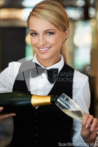 Image of Champagne, glass and portrait of woman waitress in a elegant restaurant, event or dinner. Happy, smile and young female butler from Australia pour alcohol wine at a luxury party or celebration.