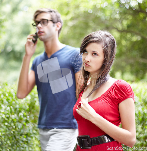 Image of Couple fight, phone call and woman frustrated by cheating man, liar or bored with relationship in a park. Smartphone, conflict and annoyed female rolling eyes for workaholic boyfriend in a forest