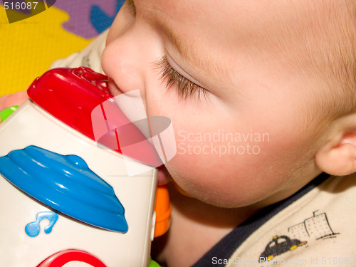 Image of Closeup of a sweet baby boy with a toy