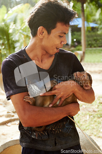 Image of Zoo, animal and man with monkey in nature for care, conservation and wildlife rescue. Sanctuary, travel and happy person with macaque in environment, ecosystem and outdoors in Thailand for tourism