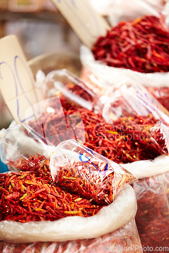 Image of Chilli, pepper and market for shopping sale, discount or wholesale promotion at vendor store or local trading. Bag of dried fruits, red vegetables and spice for food and flavor with empty background
