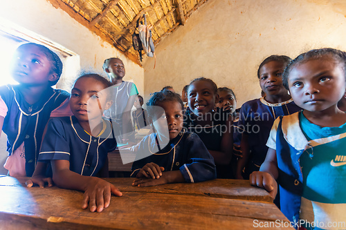 Image of Happy Malagasy school children students in classroom. School attendance is compulsory, but many children do not go to school.