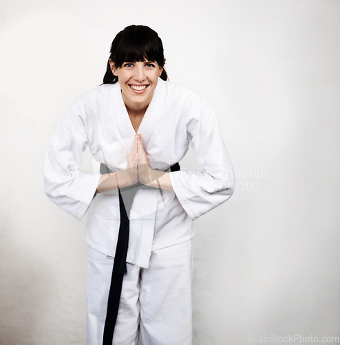 Image of Woman, karate and bow in portrait, fight and self defense sport, muay thai and training with respect. Athlete, combat and fitness, martial arts and warrior energy with taekwondo and wall background