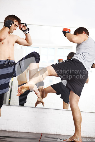 Image of Martial arts, kickboxing and men fight in gym, training and fitness with power, strong and MMA for sport. Exercise, workout and athlete in dojo, competition or contest with boxer, action and muscle