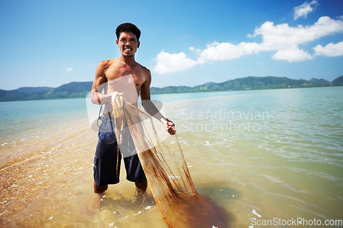 Image of Fisherman, ocean and man with net working, nature and labor with fishing in Thailand and tropical island. Sea, job and rope with worker in water to catch fish and beach with environment and portrait