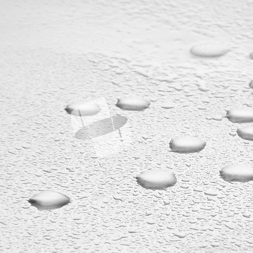 Image of Water drops, texture and splash or white background with liquid, rain condensation or morning dew. Zoom, transparent and pure droplets, raindrops or bubbles of refreshing moisture on mock up space