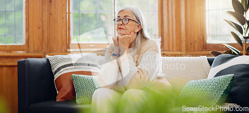 Image of Thinking, reflection and senior woman on sofa in the living room with memory or dreaming face. Relax, idea and elderly female person in retirement with alzheimers disease in the lounge of modern home