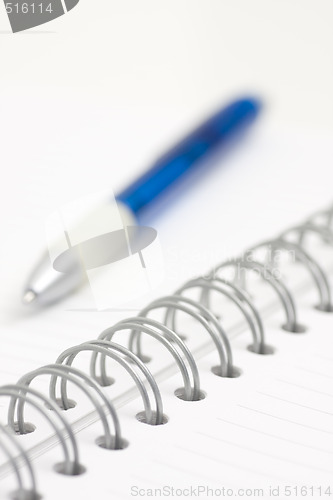 Image of pen on spiral notebook