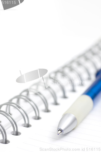Image of pen on spiral notebook