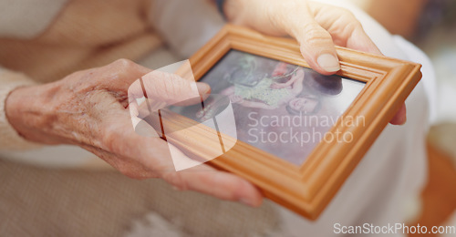 Image of Frame, picture and hands of senior person for nostalgia, memories and thinking of past in home. Retirement home, elderly and closeup of photo to remember, mourning and depression with Alzheimers