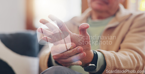 Image of Closeup, hands and senior man with wrist pain, injury and inflammation with bruise, home and broken. Zoom, pensioner and elderly guy on a couch, fingers with ache and arthritis with sprain and strain